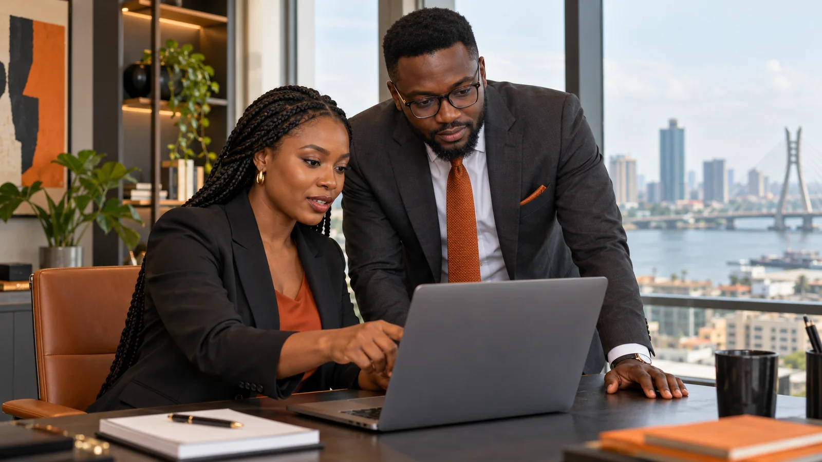 African operations professionals planning workflow automation at a laptop