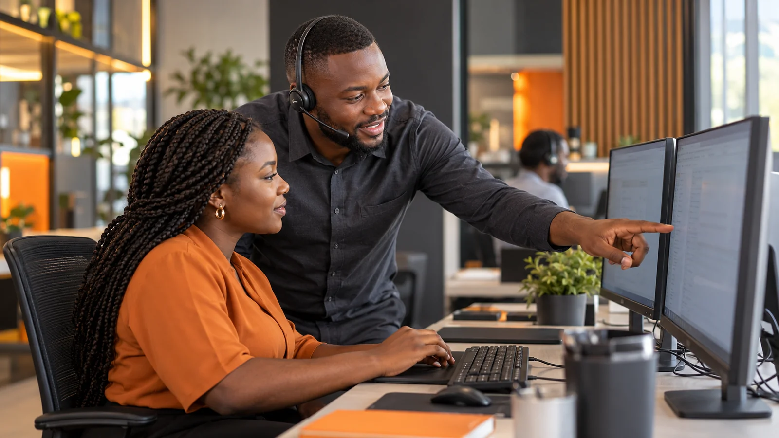 African IT support specialist working at a corporate service desk